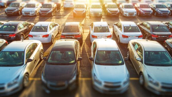 Rows of cars in a parking lot at sunset