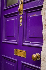 Purple door with gold handle and accents.