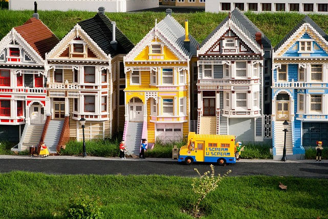 Brightly coloured houses on a street, all built in lego.
