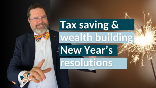 Bearded man with glasses and dark hair wearing a bright bowtie in a suit jacket, talking about wealth building new year's resolutions