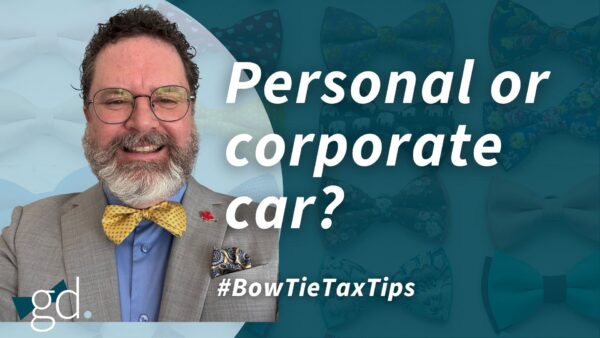 Middle-aged white male in glasses, with dark curly hair, whitish beard, and a yellow bow tie with blue shirt and gray jacket talking about claiming automobile expenses personally vs corporately