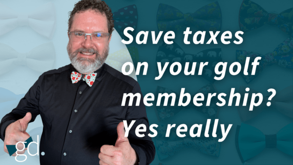 White male in glasses, white beard and mustache, curly dark hair, holding two thumbs up, wearing a black dress shirt, and white bow tie with red flowers.